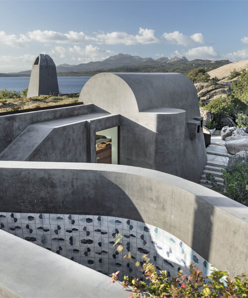 a house in sardinia by stefania stera emerges as a monolith of granite and crushed lava stone