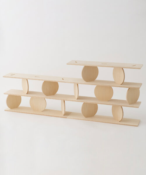 kengo kuma's modular wooden shelf with moving plates carries on ryuichi sakamoto’s design