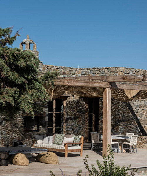 stone-clad sheep house reforms into contemporary yoga retreat in mykonos