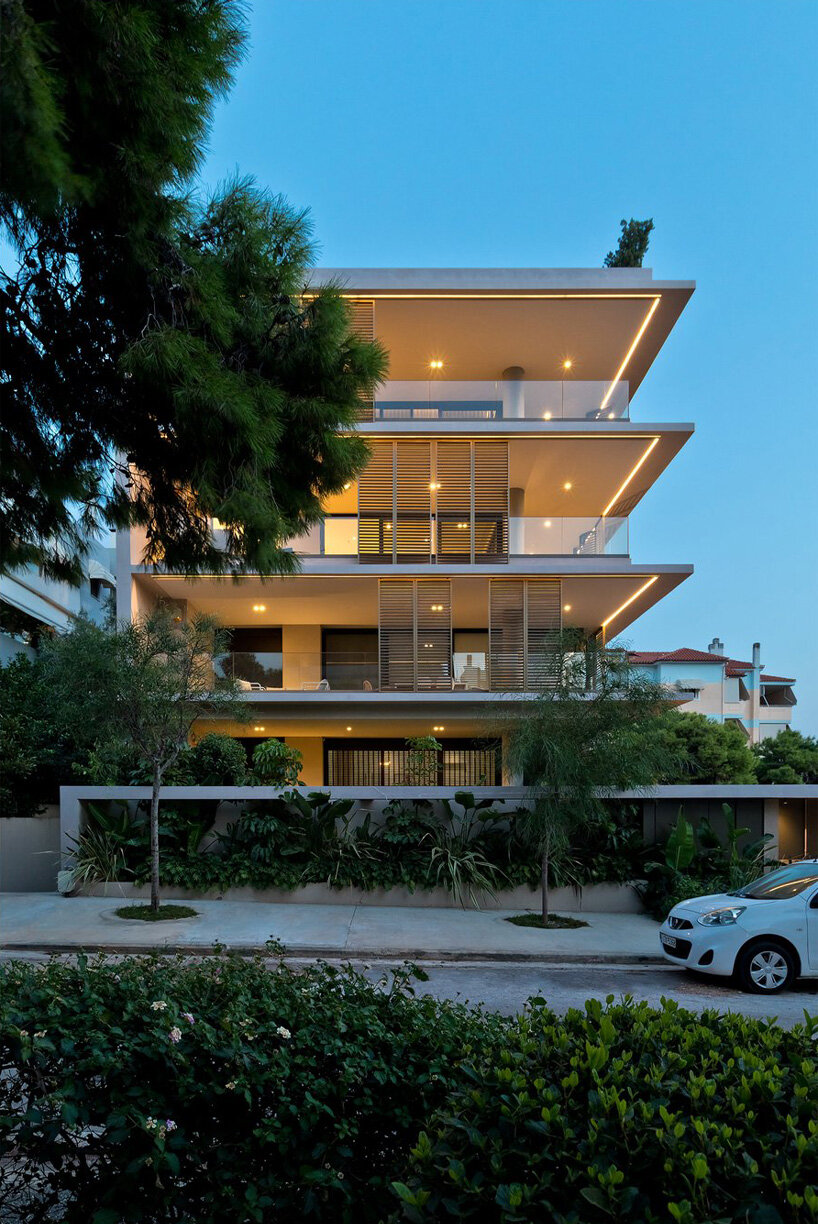 glass panes interlock between concrete slabs residential development in athens' suburbs