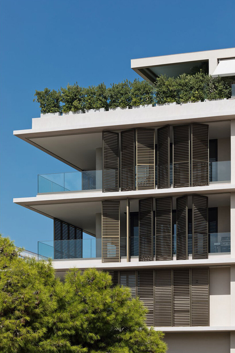 glass panes interlock between concrete slabs residential development in athens' suburbs
