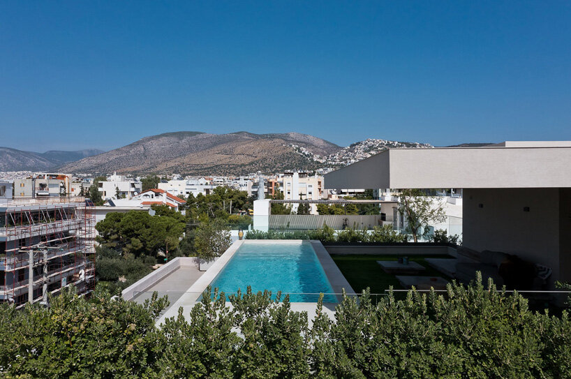 glass panes interlock between concrete slabs residential development in athens' suburbs