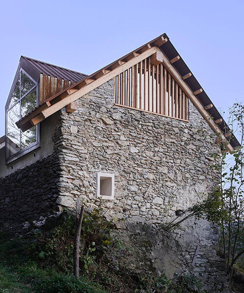 officina82 employs wood and stone to renovate abandoned rye barn in the italian alps