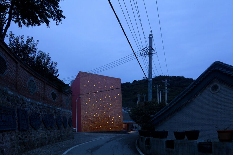 WAAAM museum's glazed yellow facade enlivens the beigou village in china
