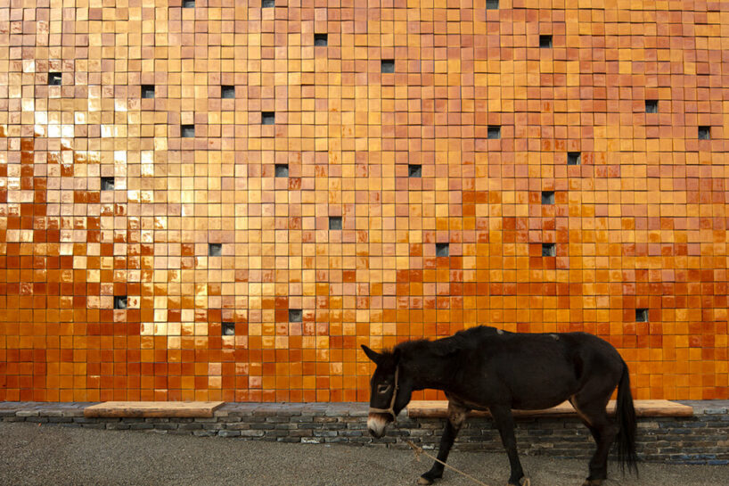 WAAAM museum's glazed yellow facade enlivens the beigou village in china