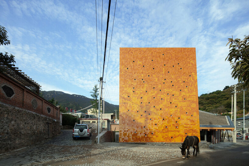 WAAAM museum's glazed yellow facade enlivens the beigou village in china