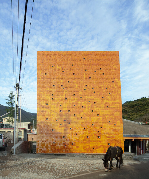 WAAAM museum's glazed yellow facade enlivens the beigou village in china