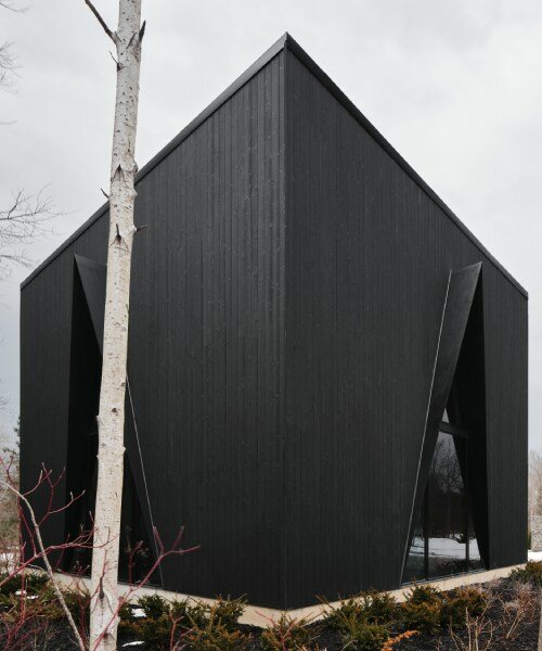 charred wood ski chalet by atelier RZLBD tucks into sloping terrain in rural canada