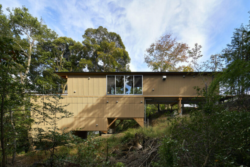 OHArchitecture embeds stepped camma villa and office onto sloping site in otsu, japan