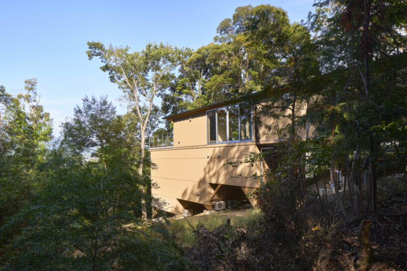OHArchitecture embeds stepped camma villa and office onto sloping site in otsu, japan