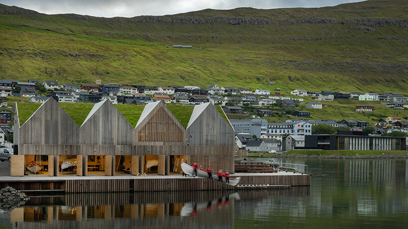 henning larsen's klaksvík row club backdropped by faroe islands' fjords