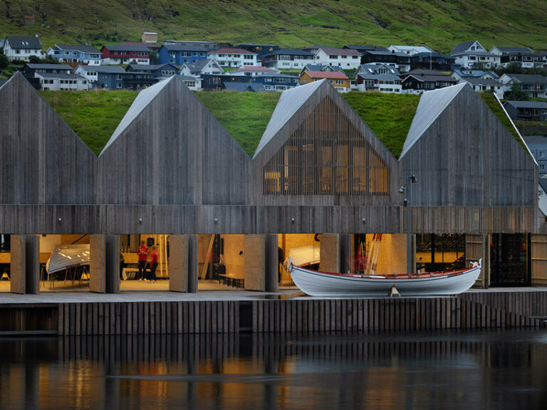 henning larsen's klaksvík row club backdropped by faroe islands' fjords