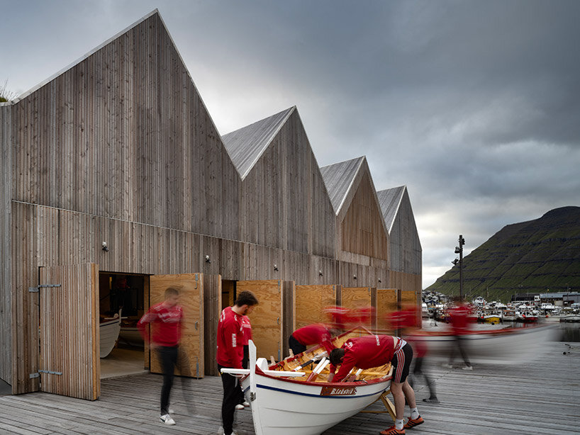 henning larsen's klaksvík row club is backdropped by the faroe islands' fjords
