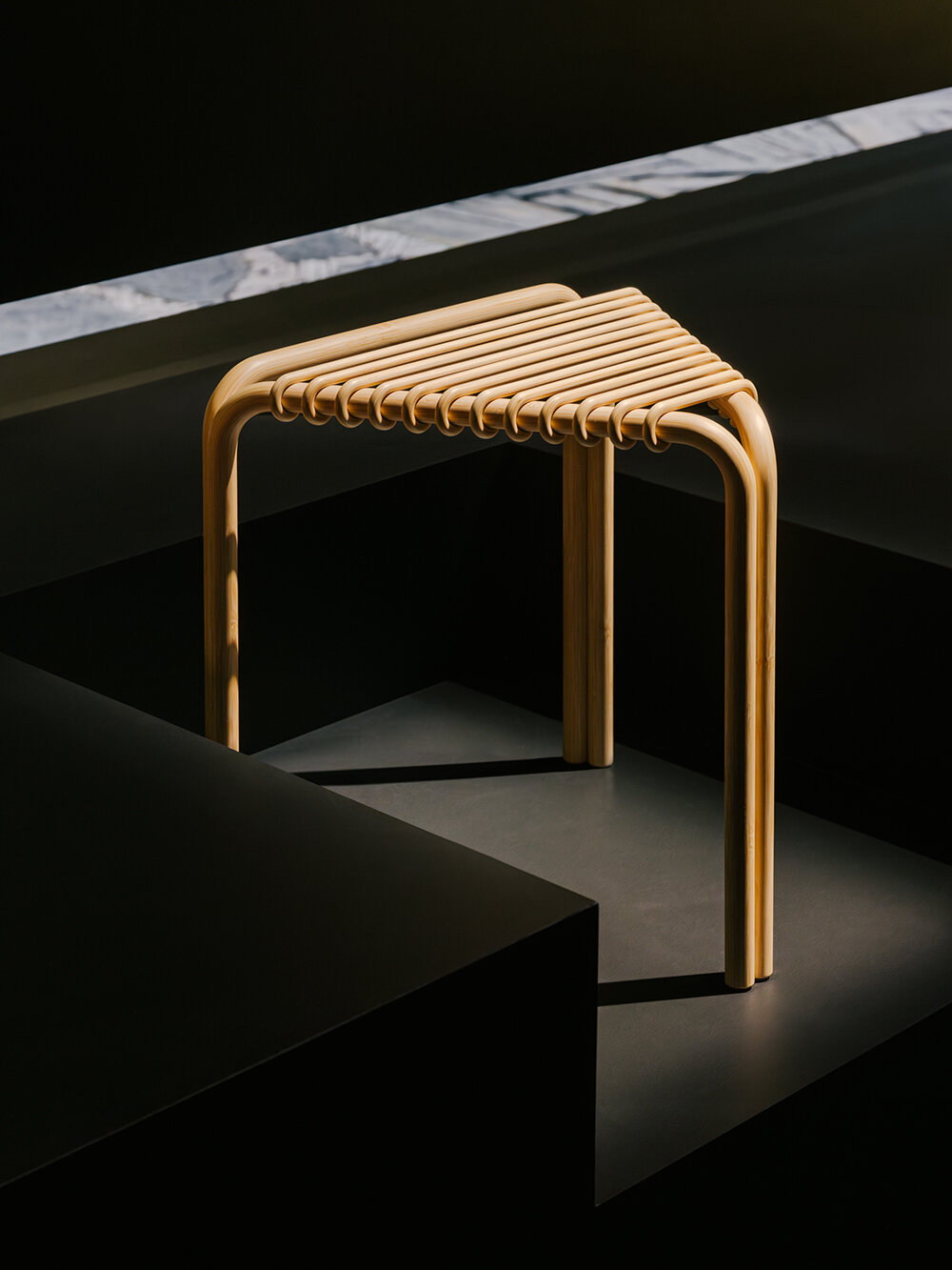Hermès depicts a jockey’s silk jersey using brick, stone, wood & earth at milan design week
