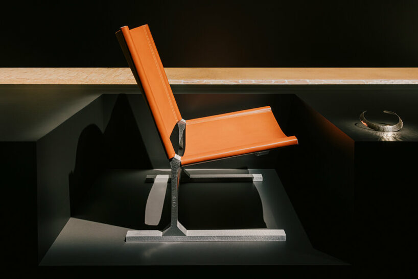 Hermès depicts a jockey’s silk jersey using brick, stone, wood & earth at milan design week