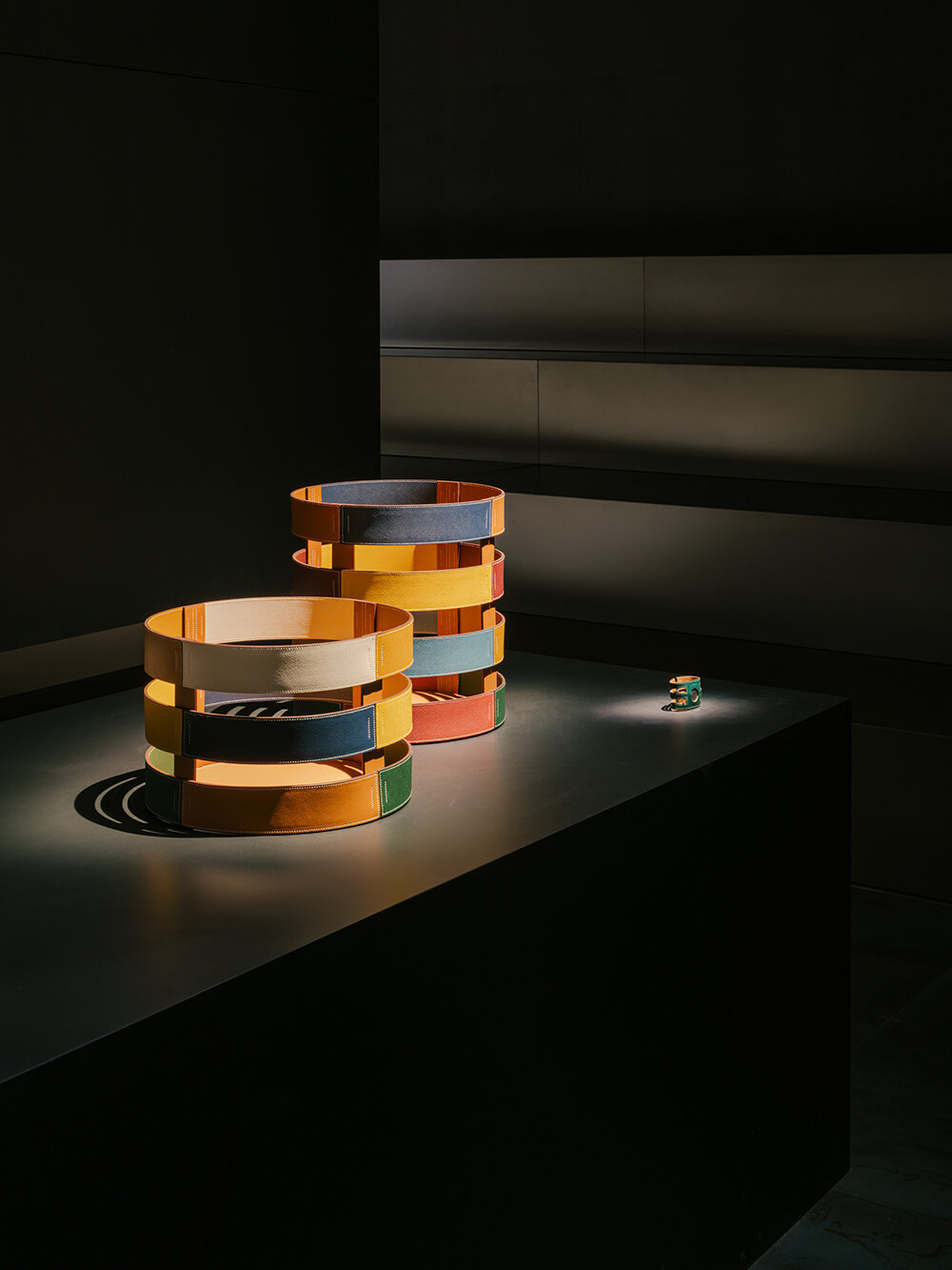 Hermès depicts a jockey’s silk jersey using brick, stone, wood & earth at milan design week