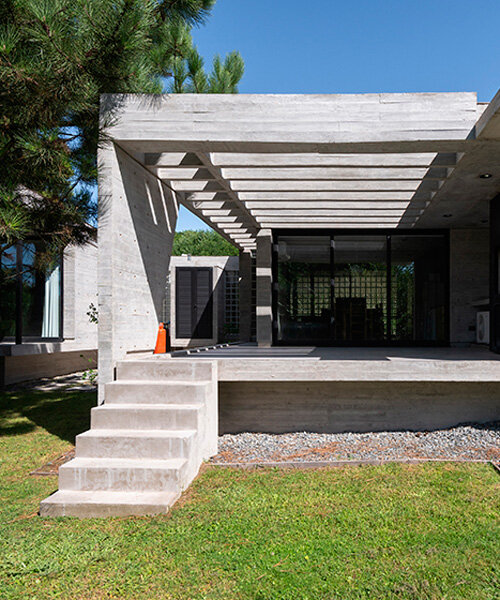 casa tres' exposed concrete volume by estudio galera floats above steep slope in argentina