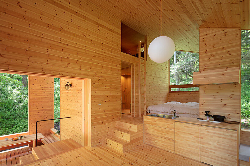 K+S architects' wooden forest hut is a terraced refuge in woods of japan