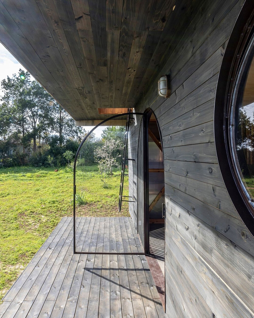 madeiguincho repurposes cargo container as tiny house with sunken roof terrace