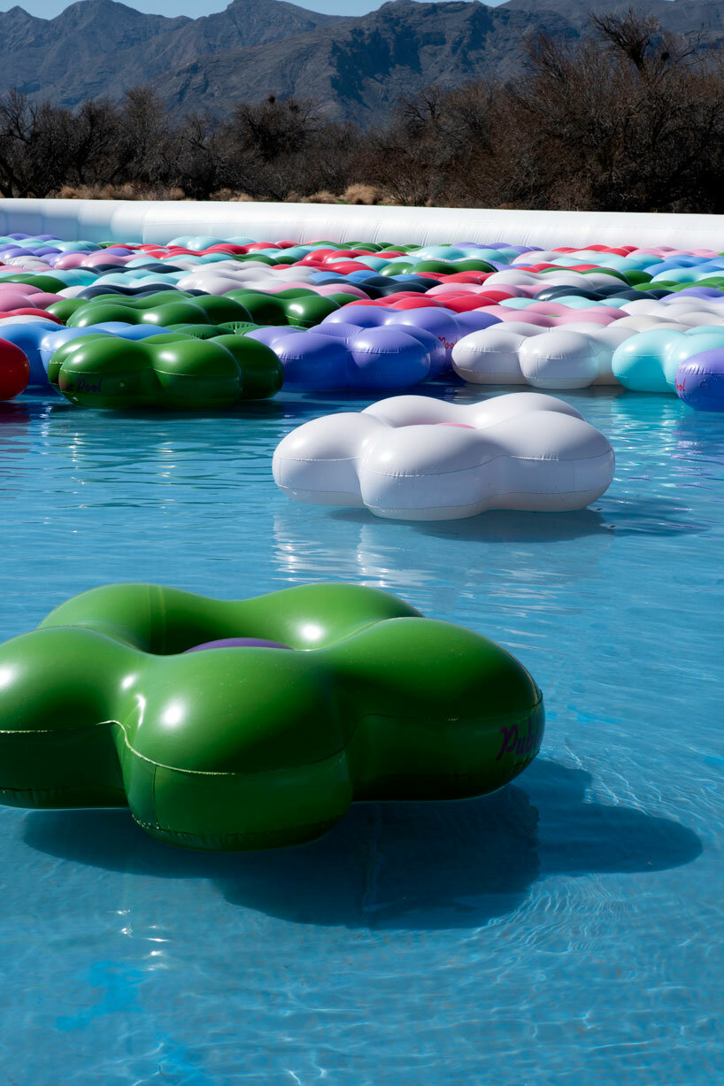 vibrant inflatable pool installation by CJ hendry pops up in the nevada desert