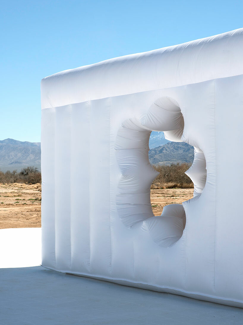 vibrant inflatable pool installation by CJ hendry pops up in the nevada desert