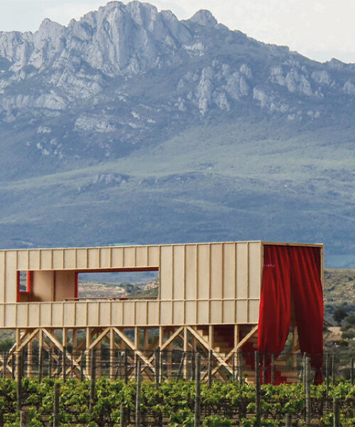 red curtains bridge the spanish vineyard with the domestic for pavilion at concéntrico
