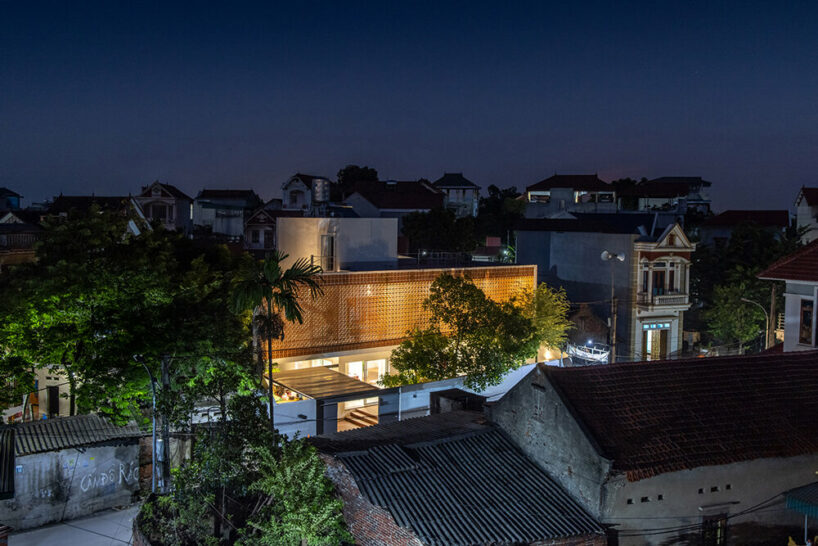 perforated double-skin brick facade shields grand house in vietnam