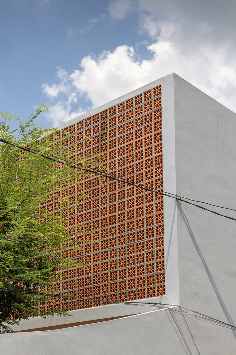 perforated double-skin brick facade shields grand house in vietnam