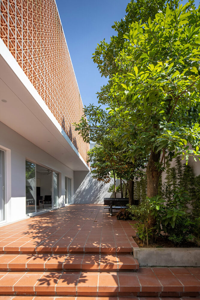 perforated double-skin brick facade shields grand house in vietnam