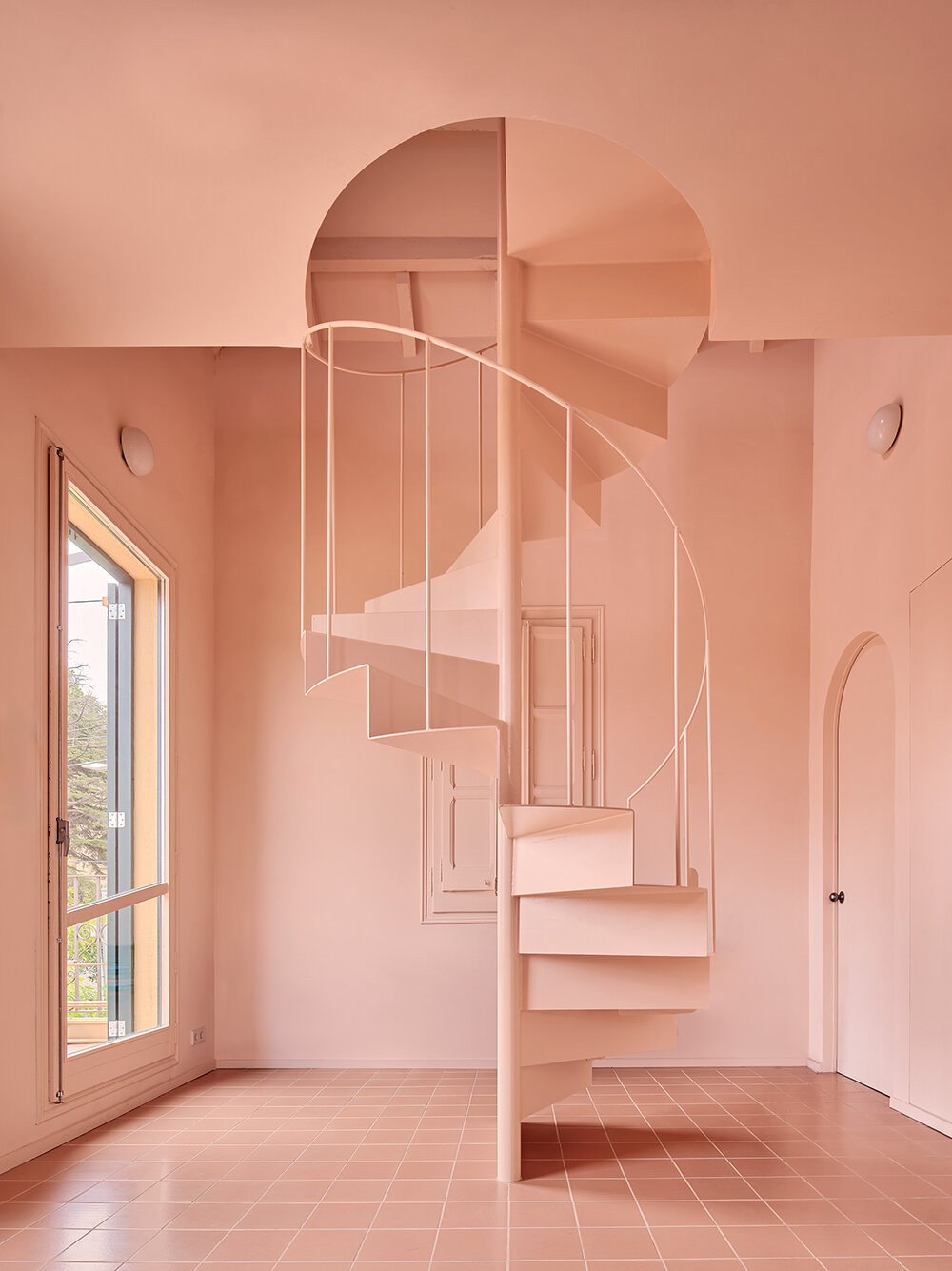 a light peach tone engulfs every corner of this two-family house in barcelona
