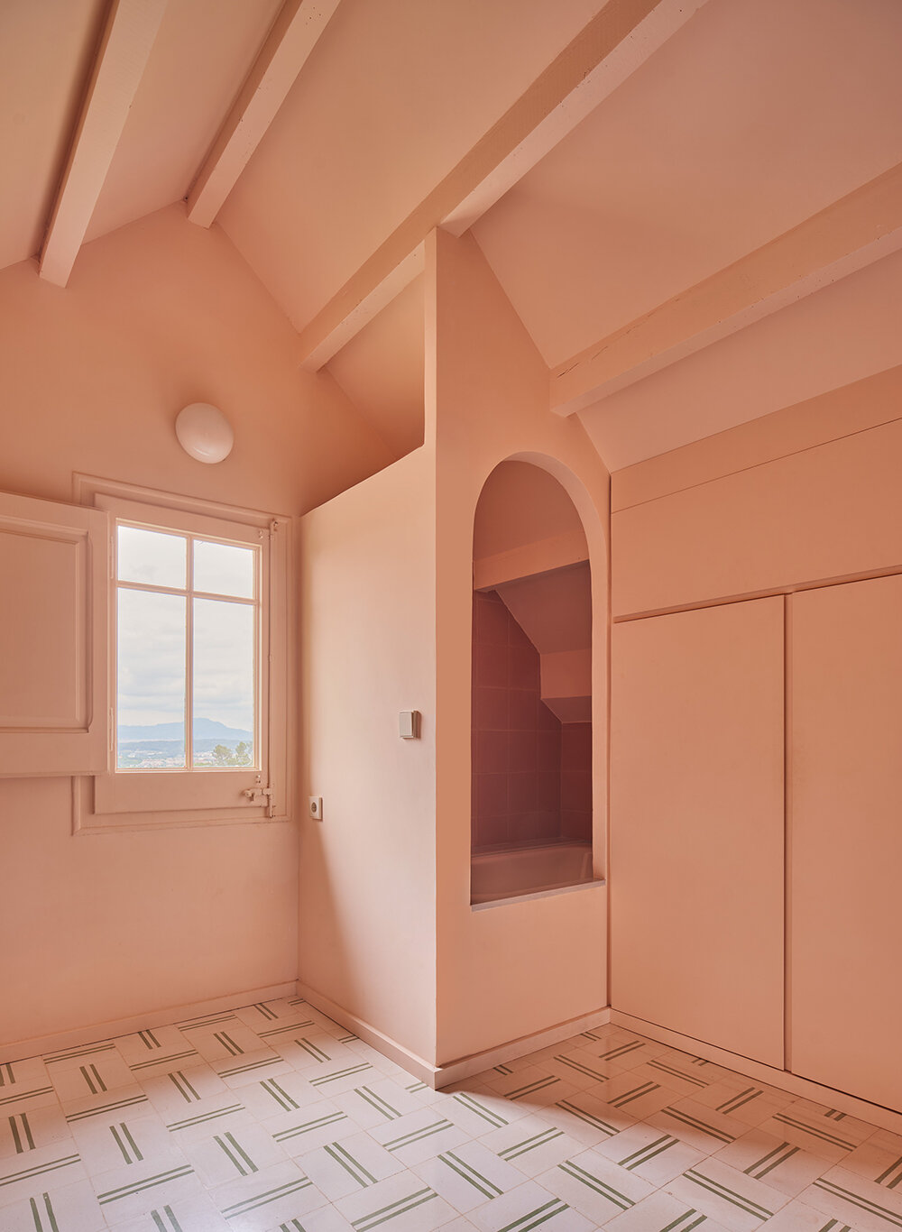 a light peach tone engulfs every corner of this two-family house in barcelona