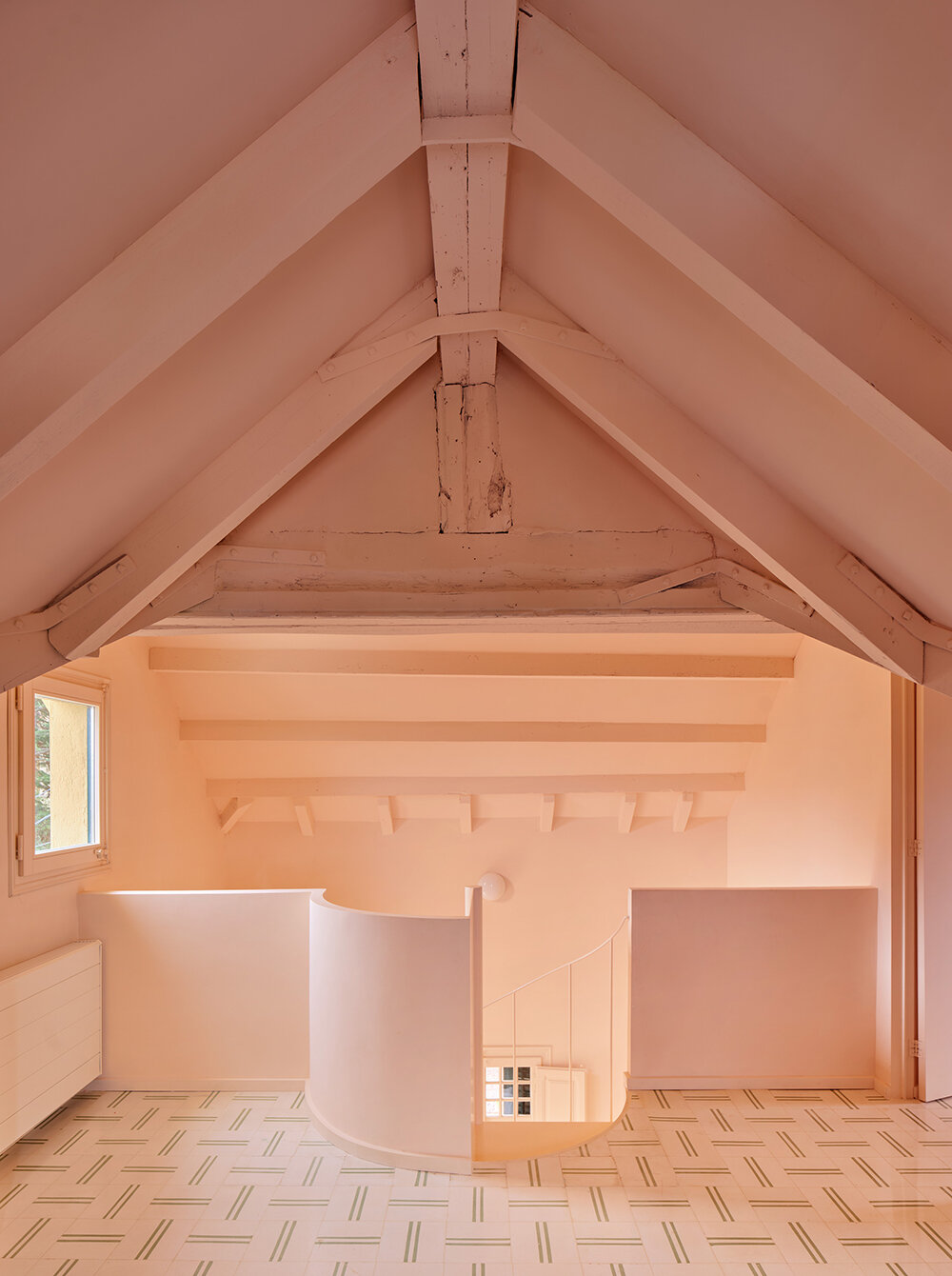 a light peach tone engulfs every corner of this two-family house in barcelona