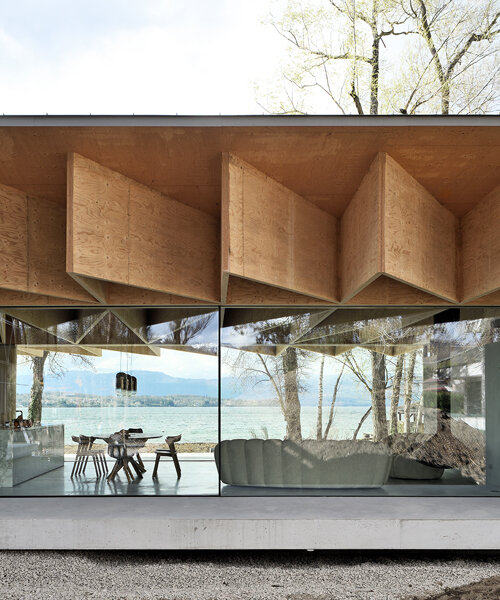 jagged wooden structure unfolds on top of ba holz house sitting along lake geneva