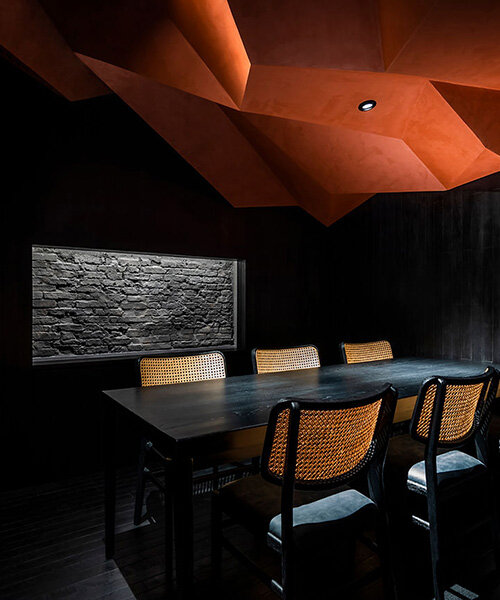 vermilion origami ceiling unfolds inside inrestudio's sushi restaurant in vietnam 
