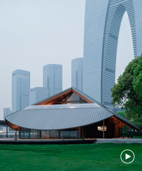 large pitched roof with curved eaves shields galaxy arch's jinji lake pavilion in china