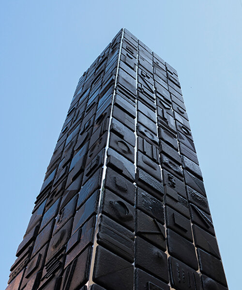 repurposed lava stones set up nerosicilia re-design tower installation for milan design week