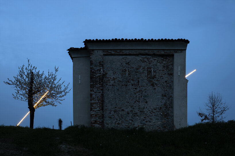 emilio ferro pierces chapel of san rocco with suspended beam of light in italy