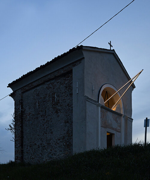 emilio ferro pierces chapel of san rocco with suspended beam of light in italy