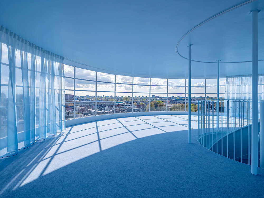 NIO house's amsterdam flagship by MVRDV culminates in an airy blue pavilion