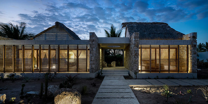 stone walls and palm-thatched palapas blend tate house into the oaxacan landscape