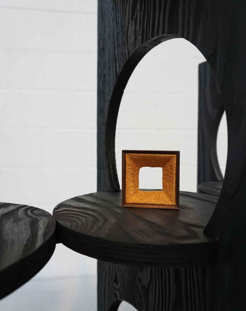 woocheol shin pierces dark wood furniture with circular openings for porthole series