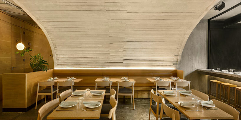 concrete arched vault shelters café-restaurant dining area in mexico city