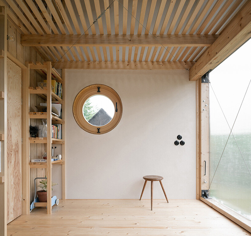 a folding, burnt-wood facade encloses BYRÓ architekti's garden pavilion