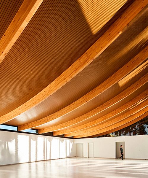 curved laminated wood beams form lightweight roof atop deportivo pavilion in cumbayá