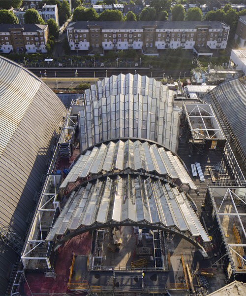 a pleated glass canopy by heatherwick studio rises amid london's olympia site