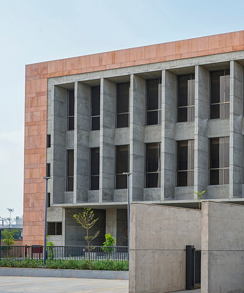 exposed concrete and pink sandstone shapes ini design studio's dahegam town hall in india