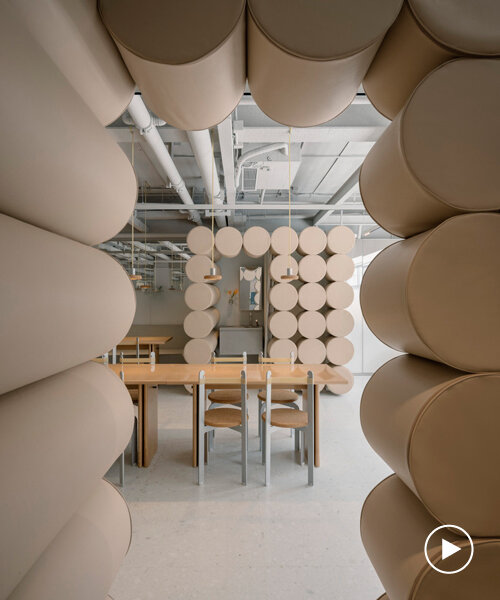 padded cylinders in soft nude colors flood noodle restaurant's interiors by office aio