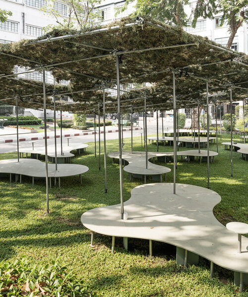people pavilion's decomposed grass canopy shades over free-form circular seating