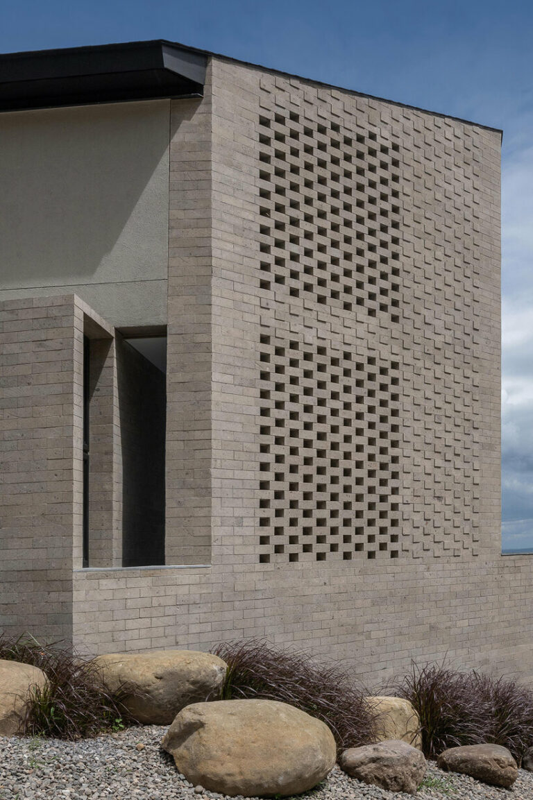 perforated adobe wall absorbs tropical heat to secure filipino residence