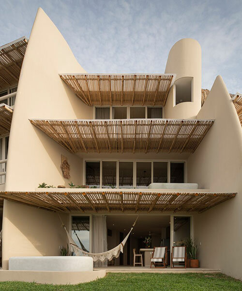sustainable coastal housing in mexico welcomes surfers to its fluid form